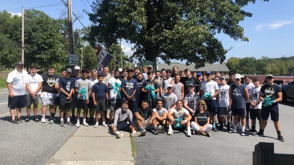 Football Turns the Town Teal day in Goshen. Team Up 4 Community