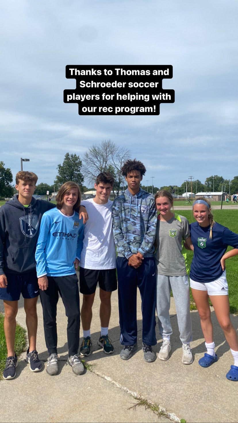 Thomas and Schroeder soccer players helping with Lakefront Soccer